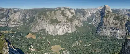 Granite cliffs and Half Dome above forested Yosemite Valley from Glacier Point, California