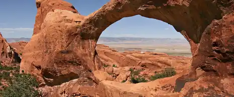 Double O Arch of red sandstone in Arches National Park, Utah